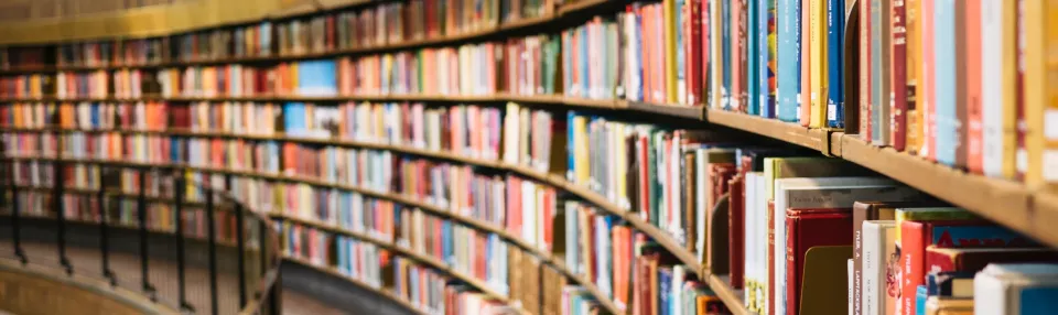Curved library shelves filled with books.