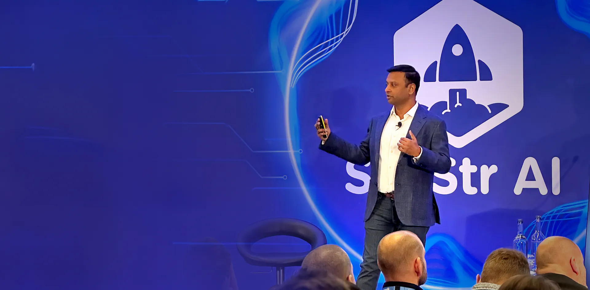 Shalin Jain speaking on stage at SaaStr AI