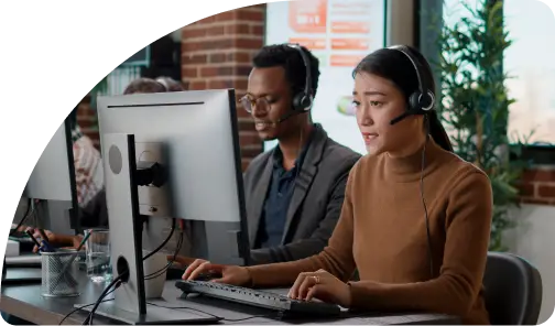 Call center agents working at computer displays