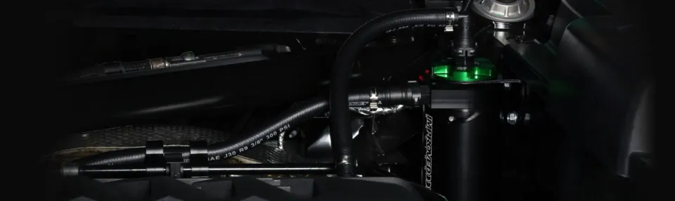 Improved Racing automotive components installed in an engine bay.