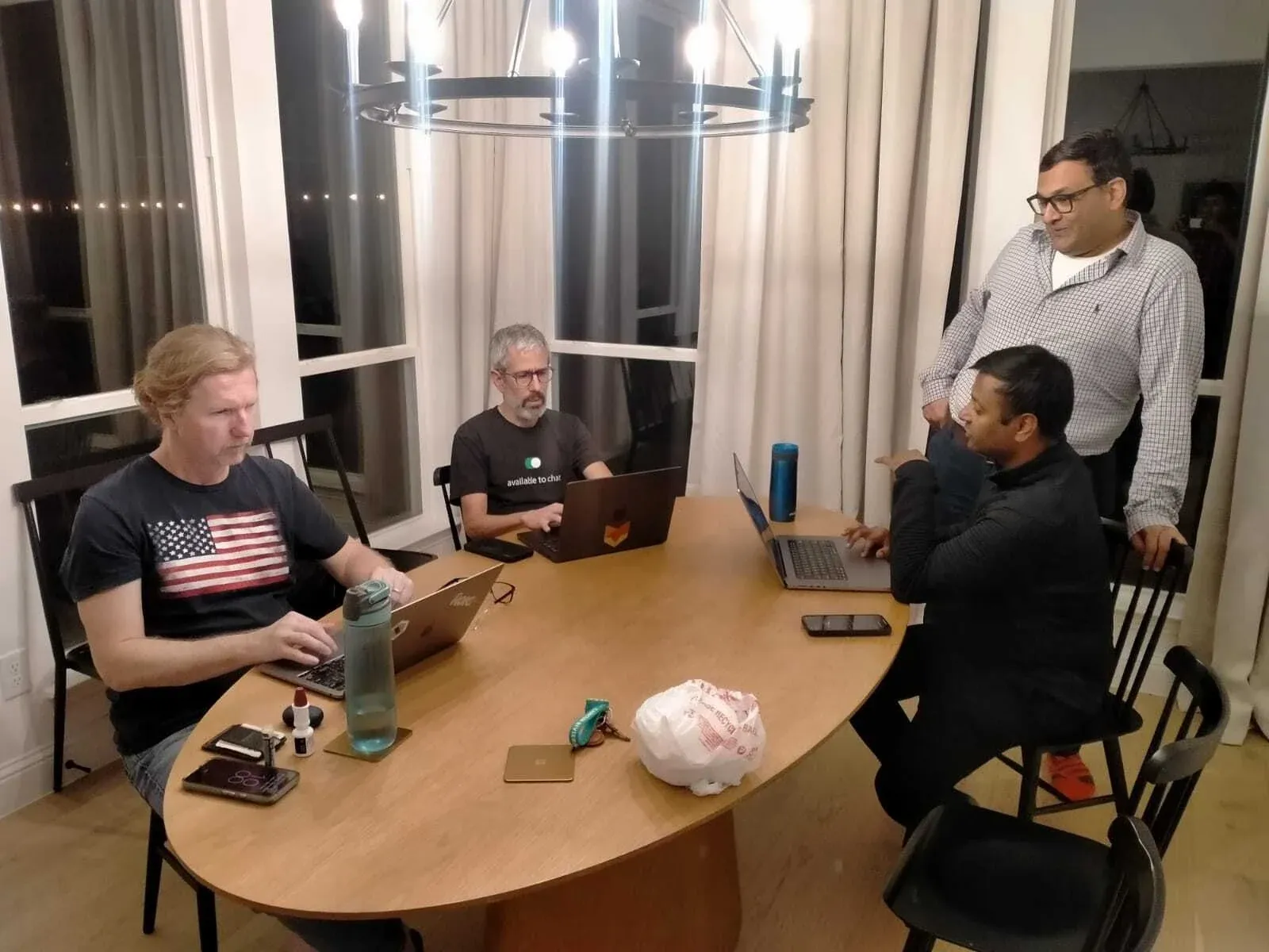 HappyFox colleagues collaborating around a meeting table.