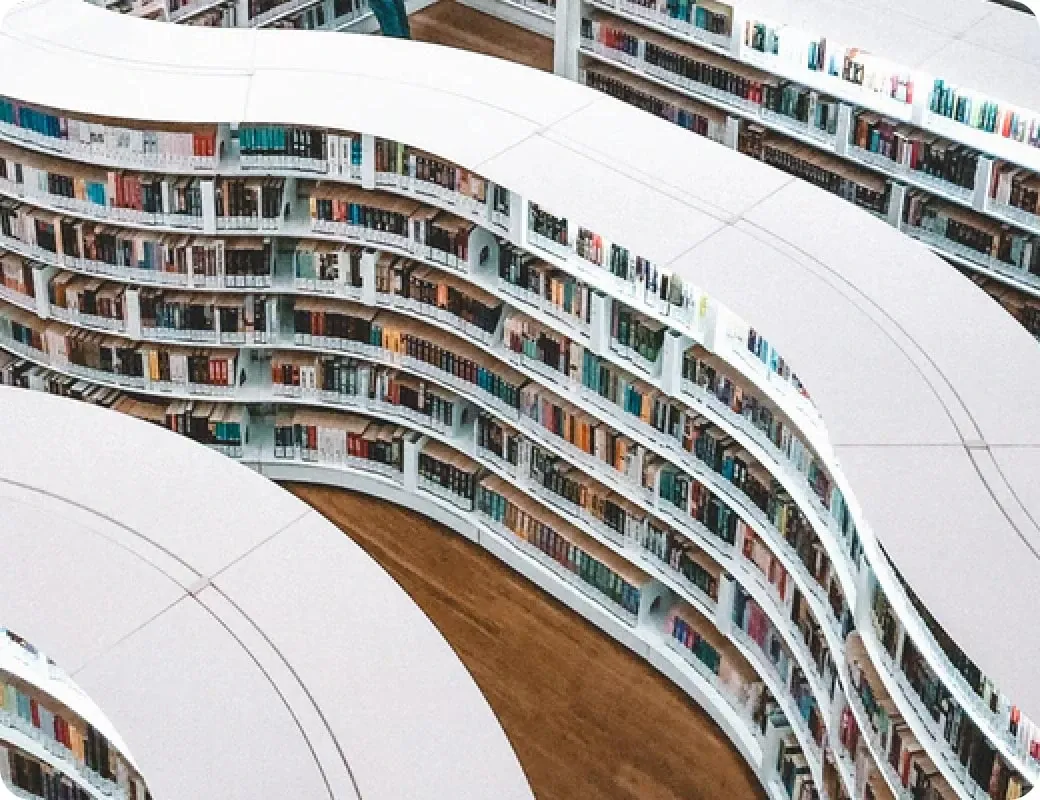 Curved library shelves filled with books.