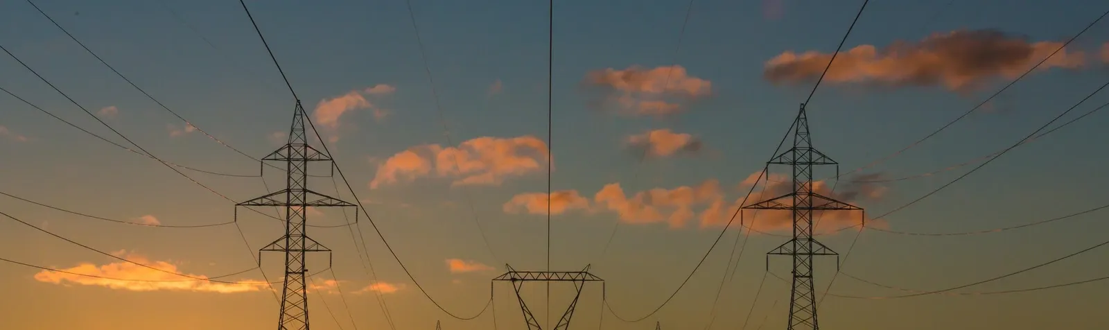 Electricity transmission infrastructure at sunset.