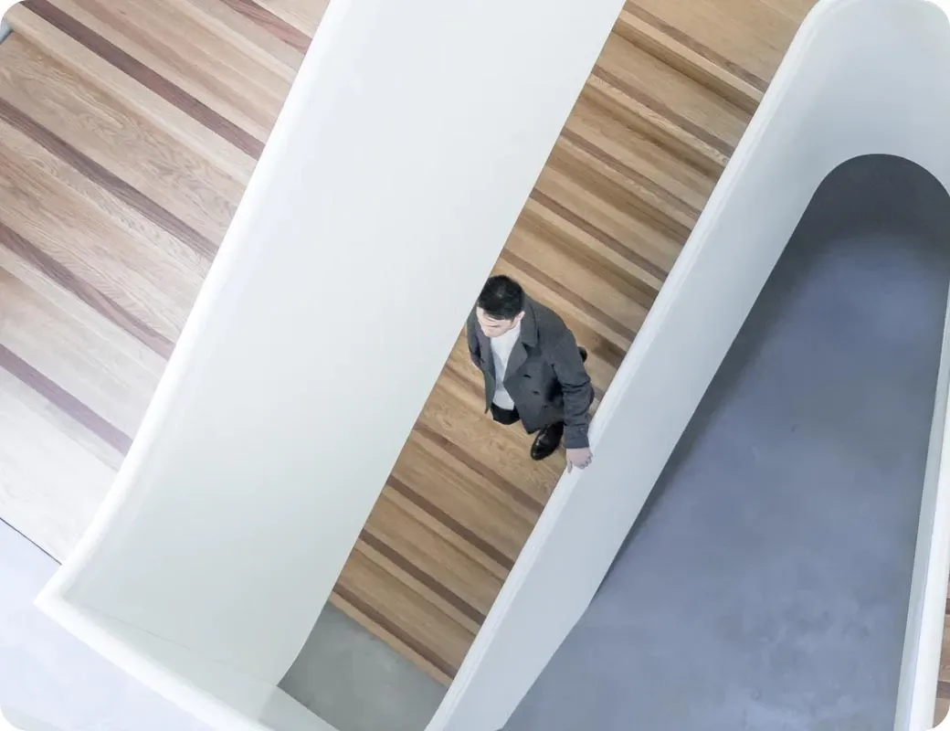 An overhead view of a person moving through an office building.